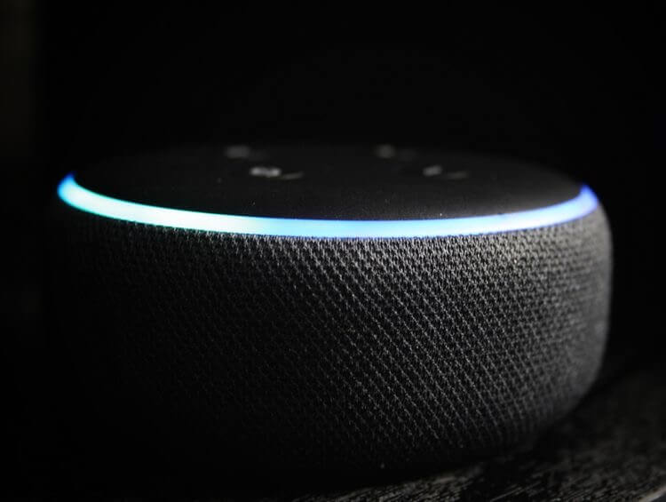Amazon Alexa Echo Dot against a dark background